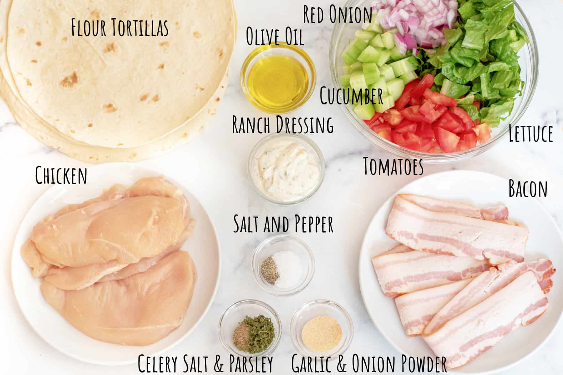 tortillas, oil, a bowl with lettuce, onions, tomatoes, cucumbers, bowls with ranch dressing, spices and seasonings, a plate of uncooked bacon and raw chicken all labeled.