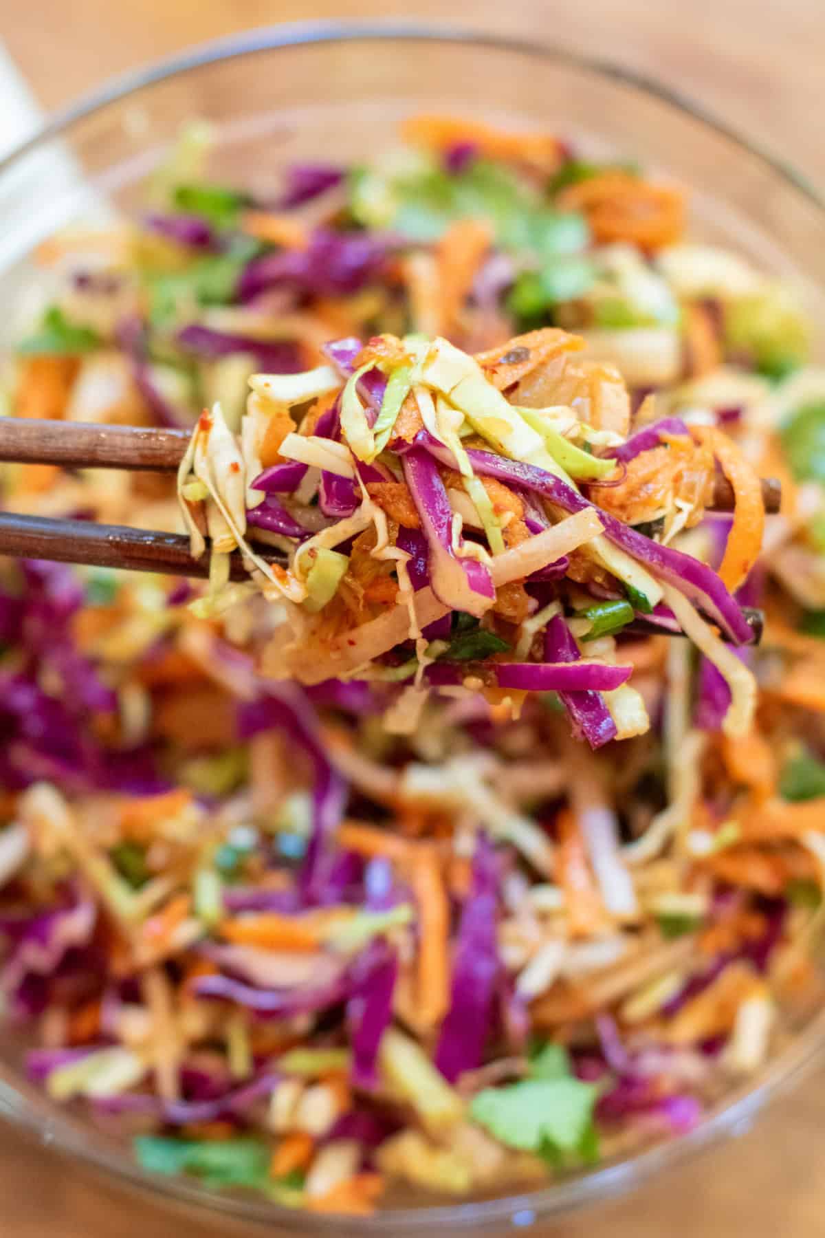 chopsticks holding up some cabbage slaw.