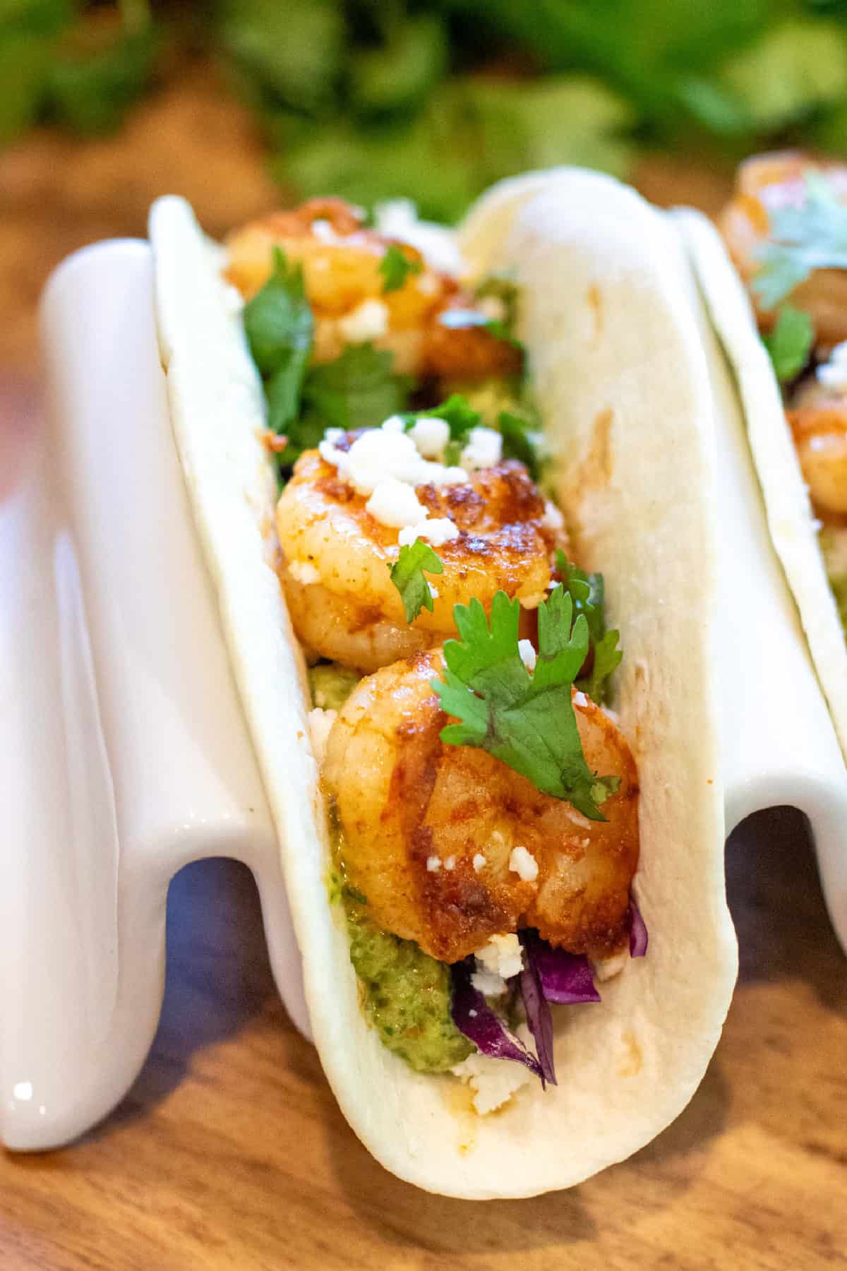 a taco with shrimp in a holder.