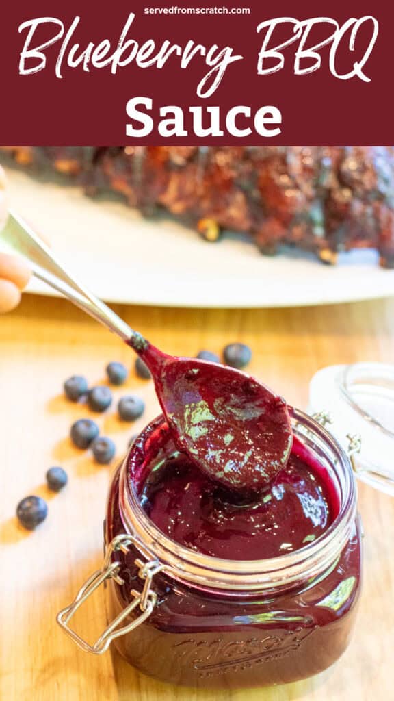 an open mason jar with a spoon and blueberry bbq sauce with Pinterest pin text.