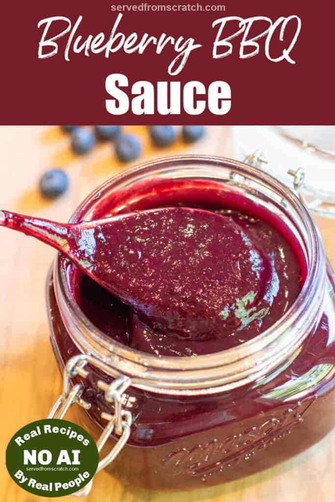 an open mason jar with a spoon and blueberry bbq sauce with Pinterest pin text with NO AI sticker.