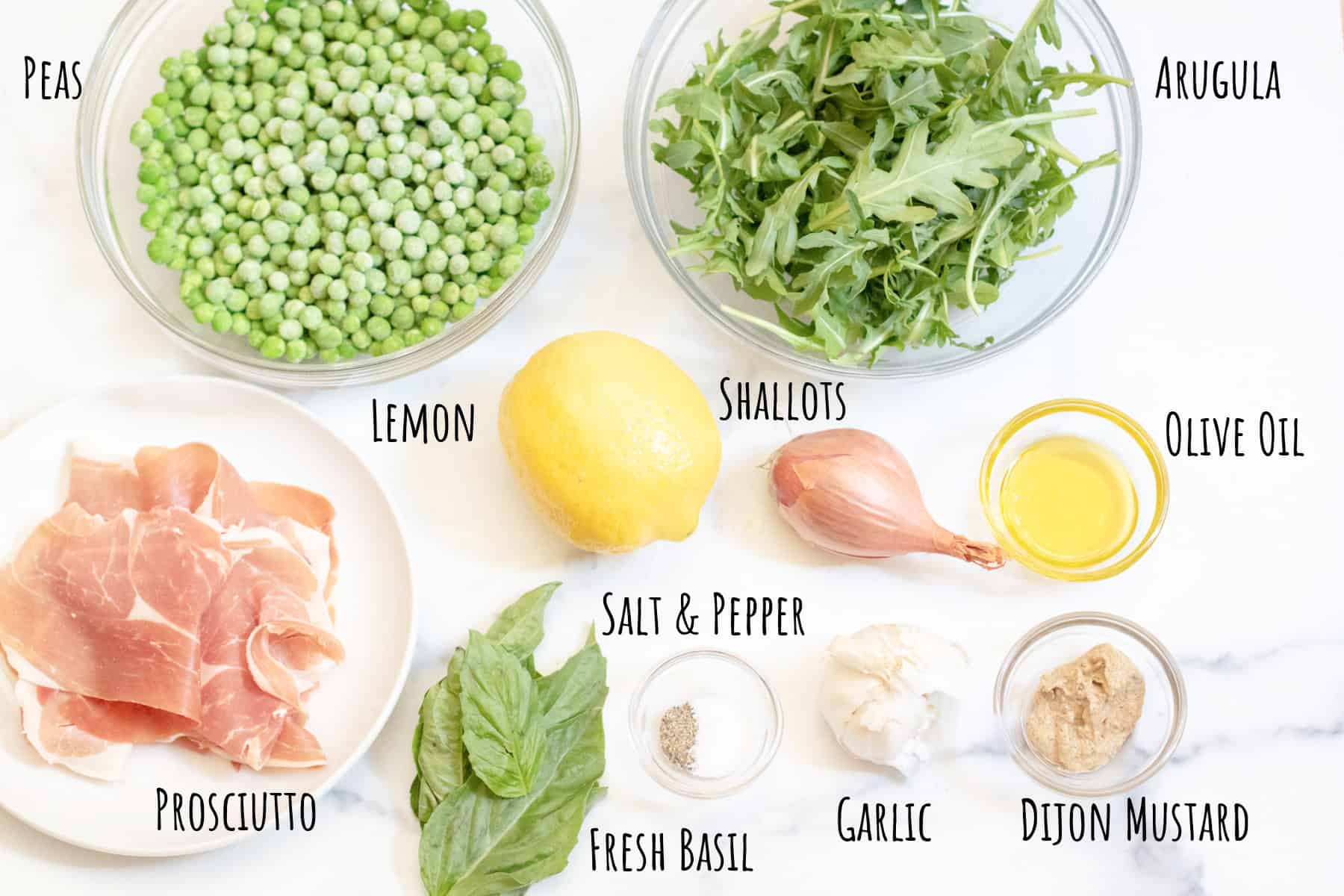 a bowl of peas, arugula, prosciutto, fresh basil, lemon, shallot, olive oil, dijon, salt and pepper, garlic all labeled.