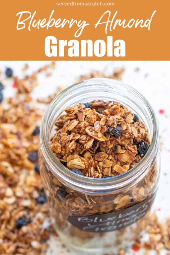 a picture of an open labeled mason jar of blueberry almond granola with Pinterest pin text.