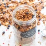 a picture of an open labeled mason jar of blueberry almond granola.