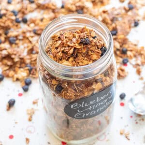 a picture of an open labeled mason jar of blueberry almond granola.