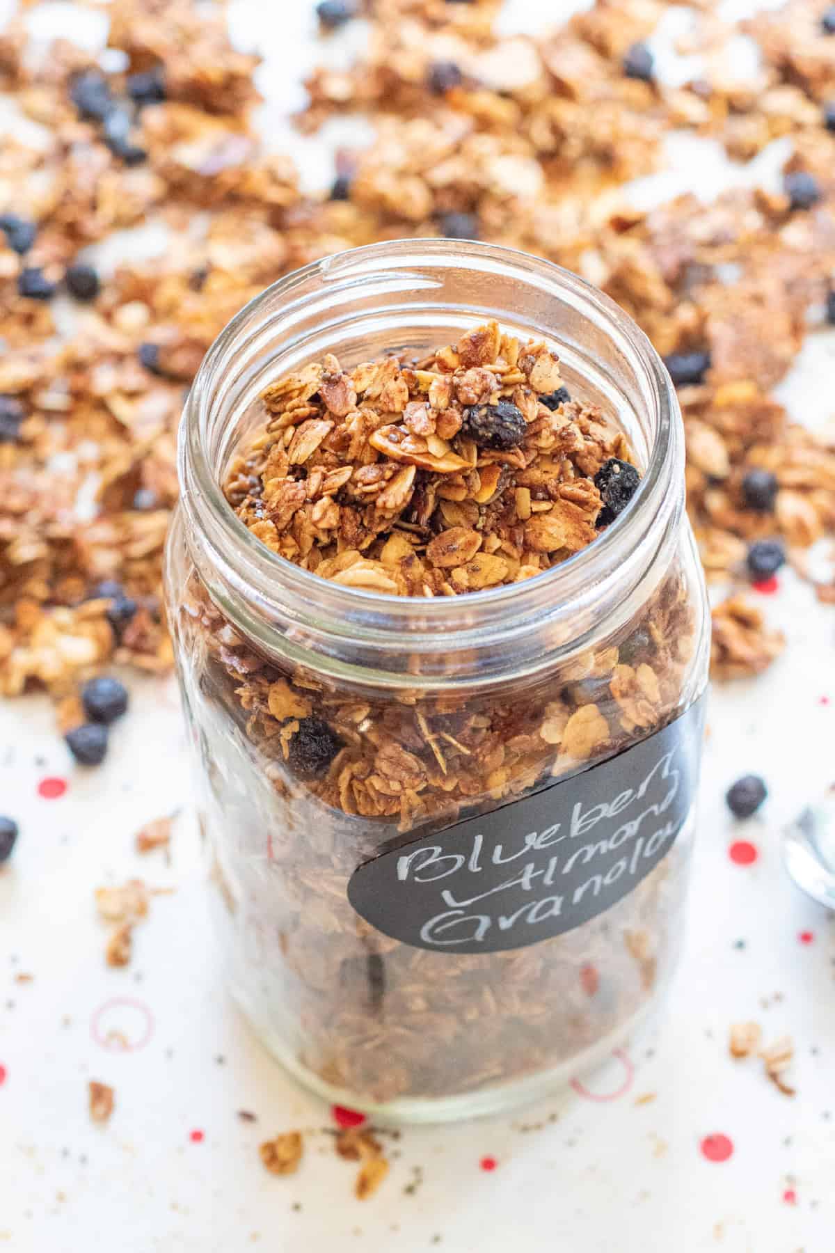 a picture of an open labeled mason jar of blueberry almond granola.