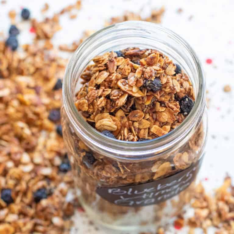 a picture of an open labeled mason jar of blueberry almond granola.