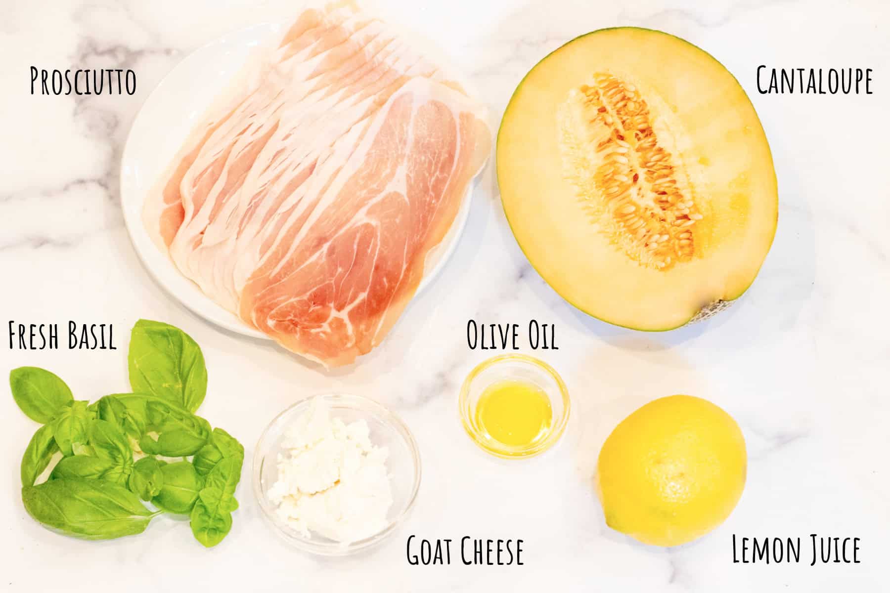 a plate of prosciutto, half a cantaloupe, fresh basil, olive oil, goat cheese, and a lemon all labeled.