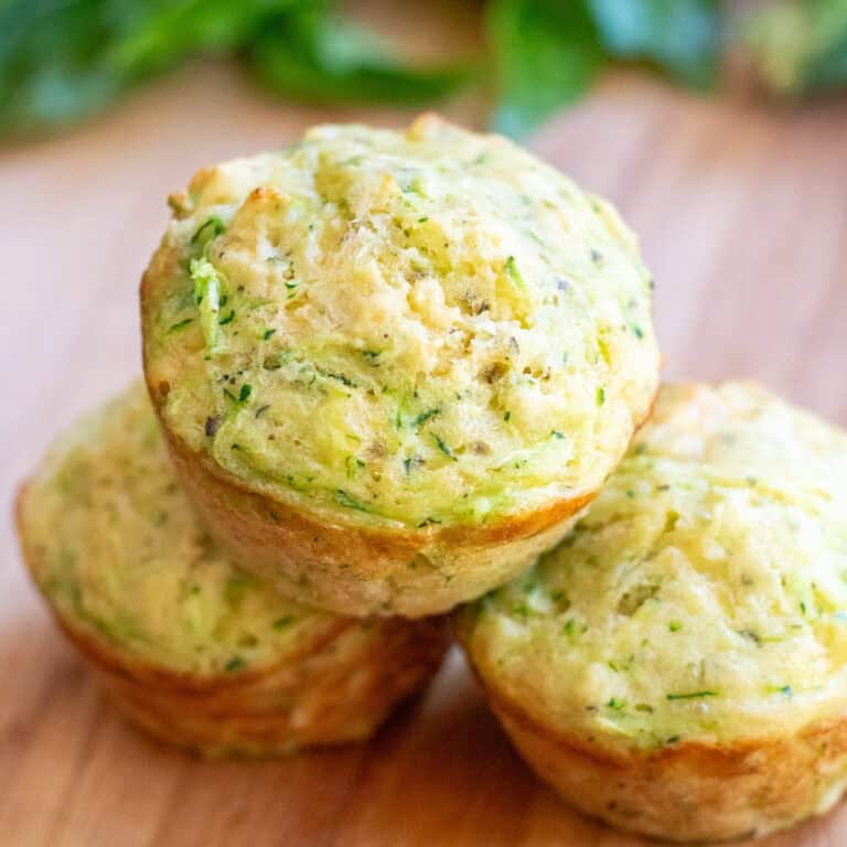 3 zucchini muffins stacked.