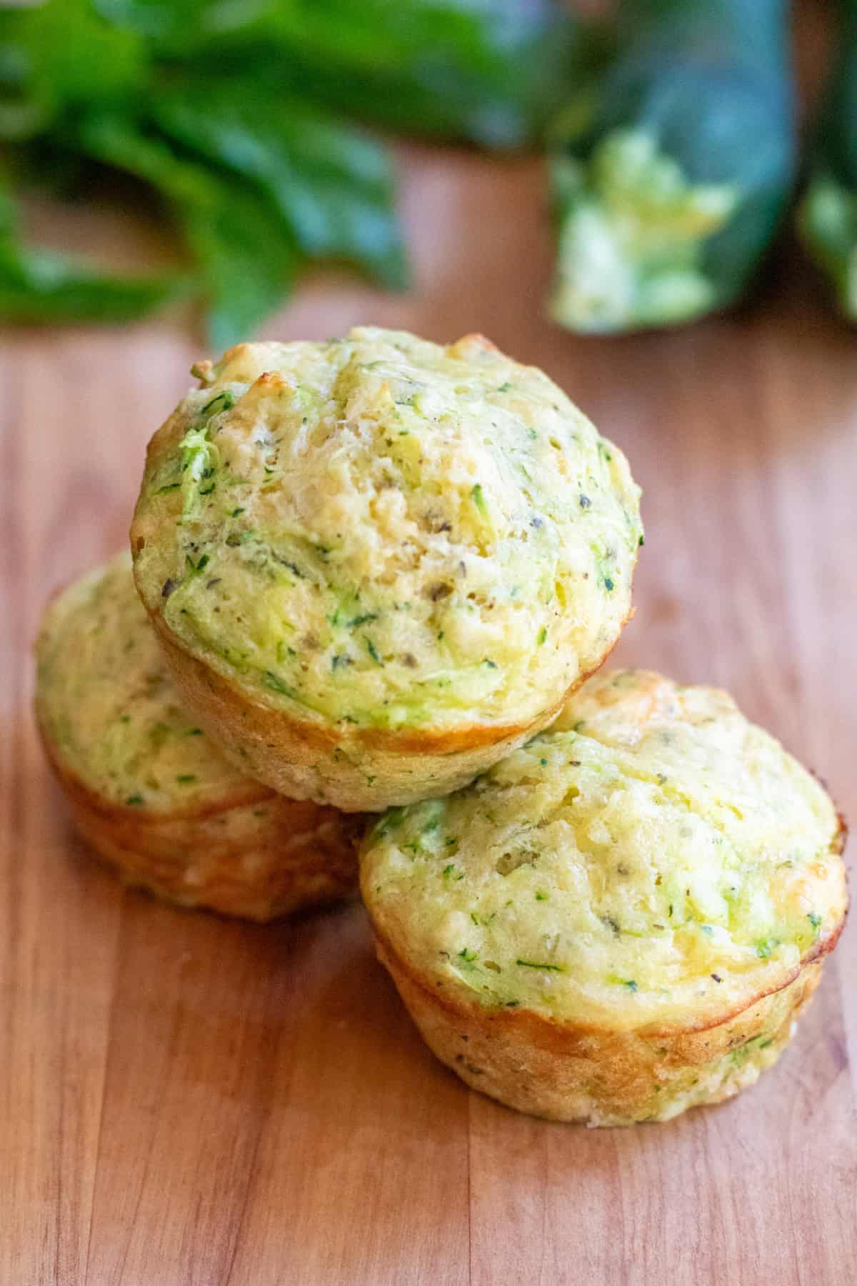 3 zucchini muffins stacked.