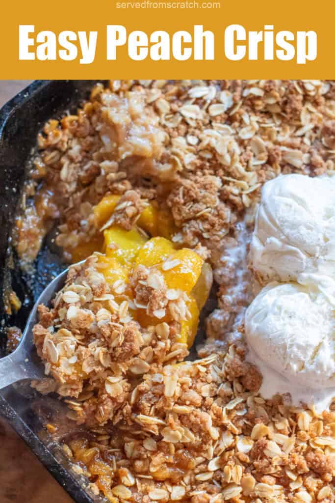 a cast iron of peach crisp with ice cream and a spoon take a scoop out with PInterest pin text.