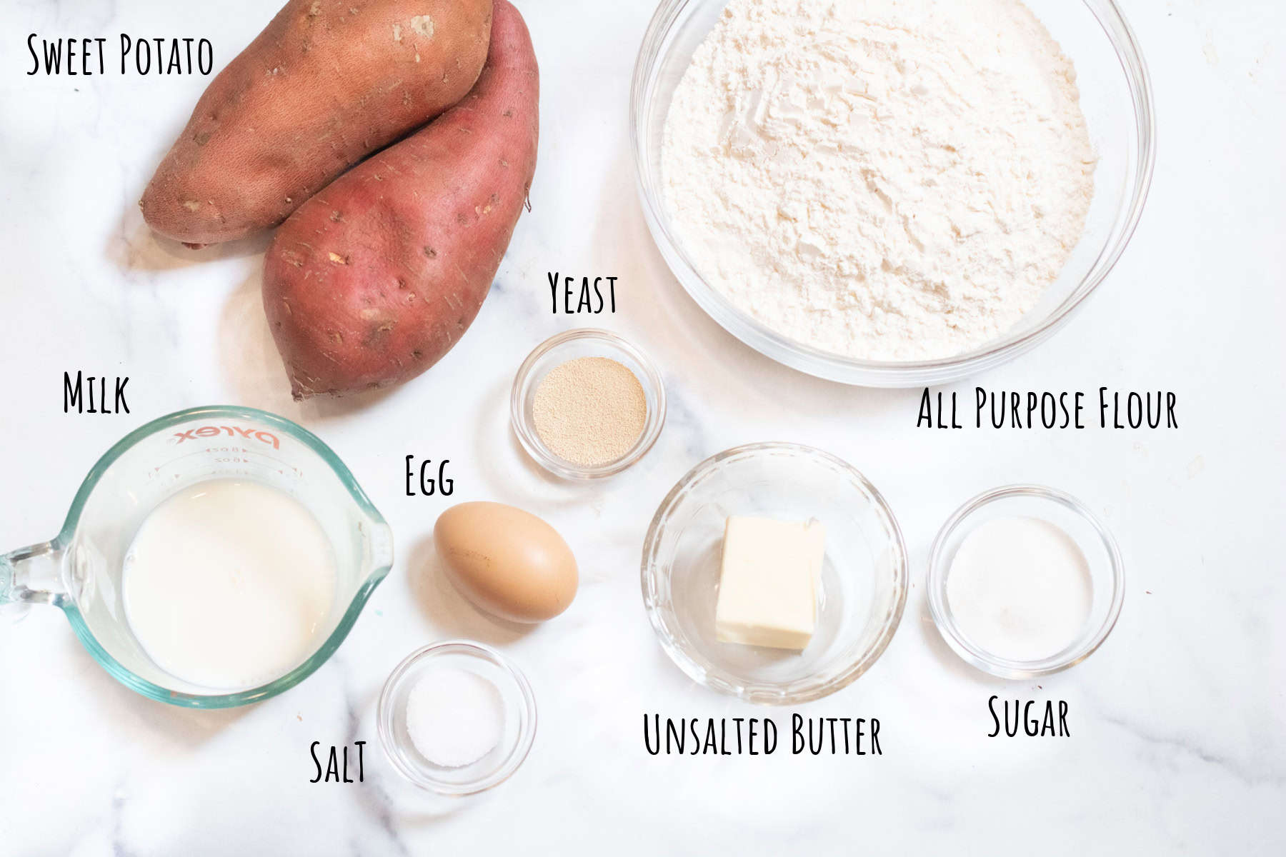 sweet potatoes, a bowl of flour, milk, egg, yeast, butter, sugar, and salt labeled.