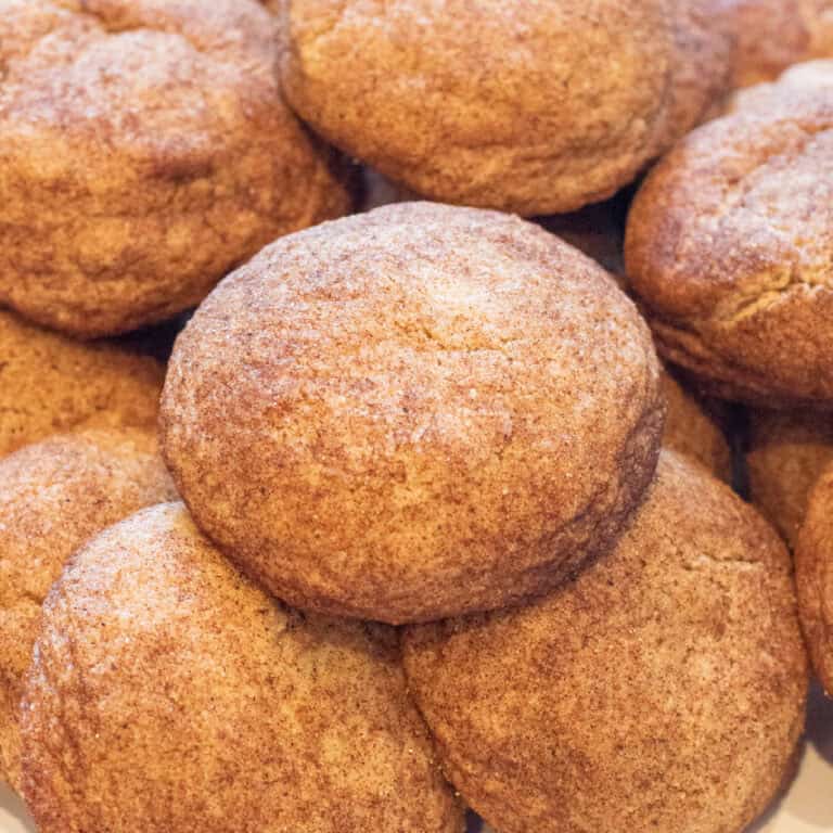 thick soft snickerdoodle cookies all stacked together.