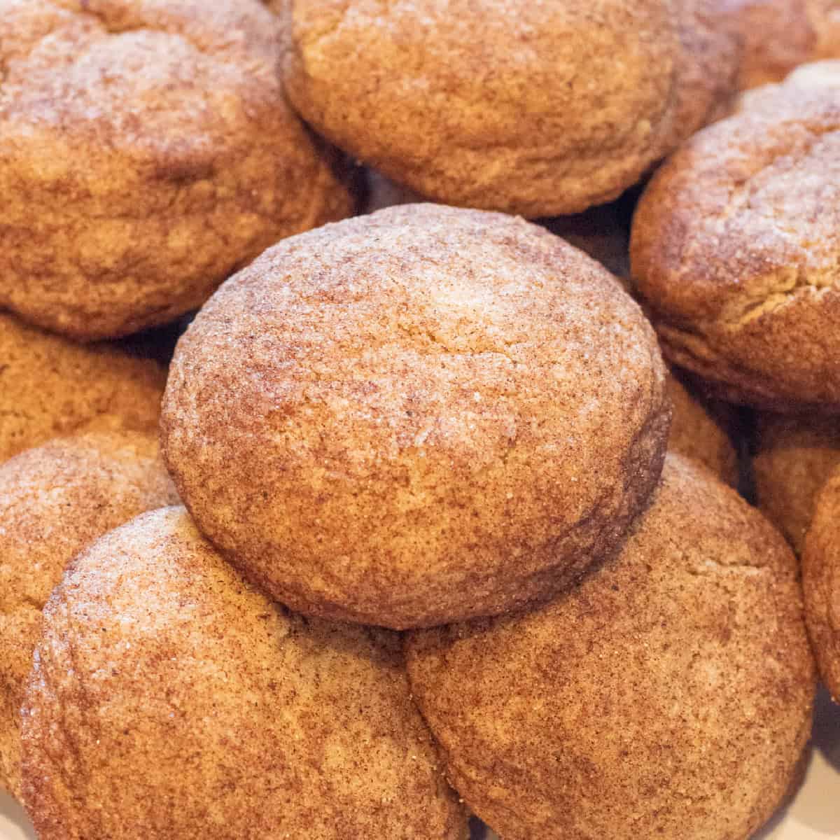 thick soft snickerdoodle cookies all stacked together.