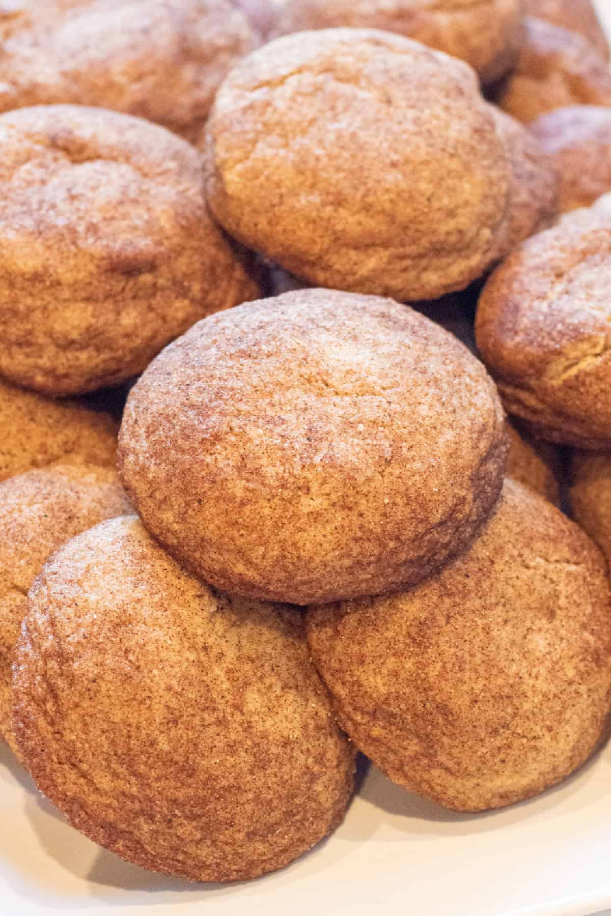 thick soft snickerdoodle cookies all stacked together.