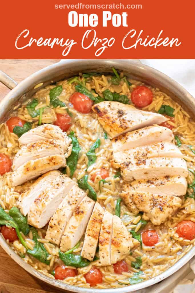 an overhead of a skillet with cooked sliced chicken and orzo and spinach and tomatoes with Pinterest pin text.