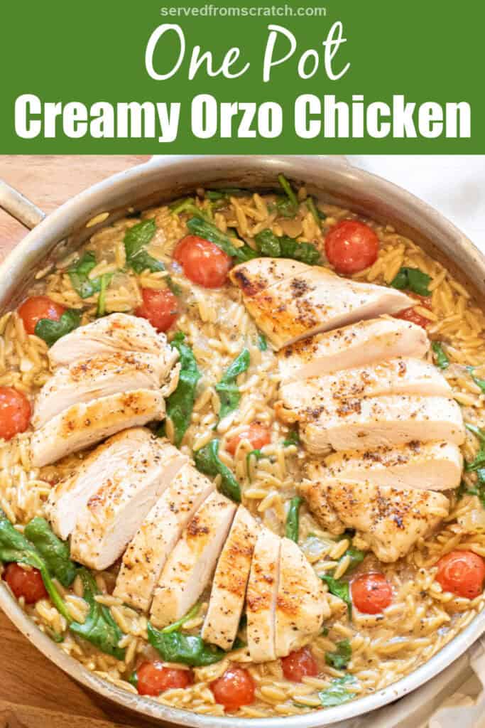 an overhead of a skillet with cooked sliced chicken and orzo and spinach and tomatoes with Pinterest pin text.
