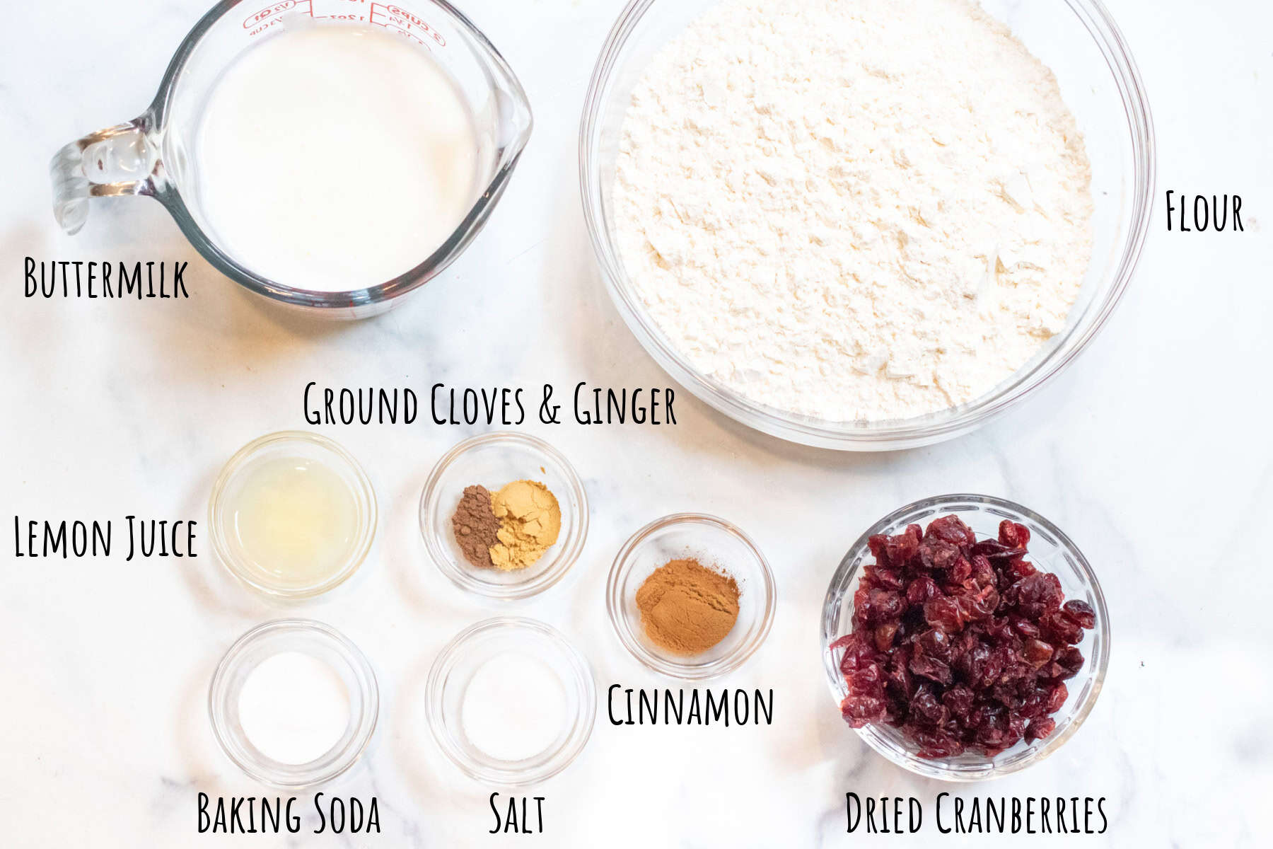 buttermilk, flour, lemon juice, spices, cranberries, baking soda, and salt all labeled.