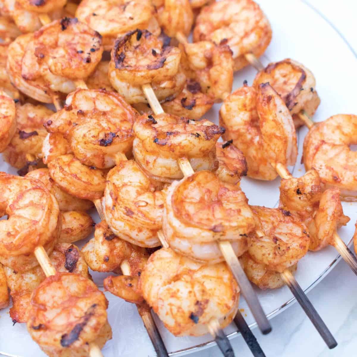 grilled shrimp skewers on a plate.