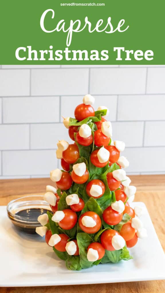 a christmas tree shaped caprese tree with a bowl of balsamic with Pinterest pin text.
