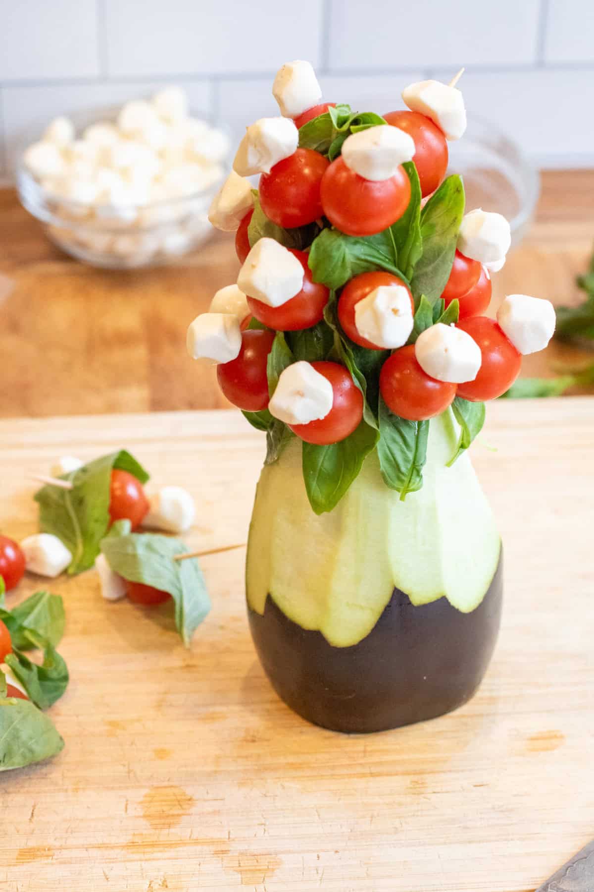 a shaped eggplant with caprese skewers poking out.