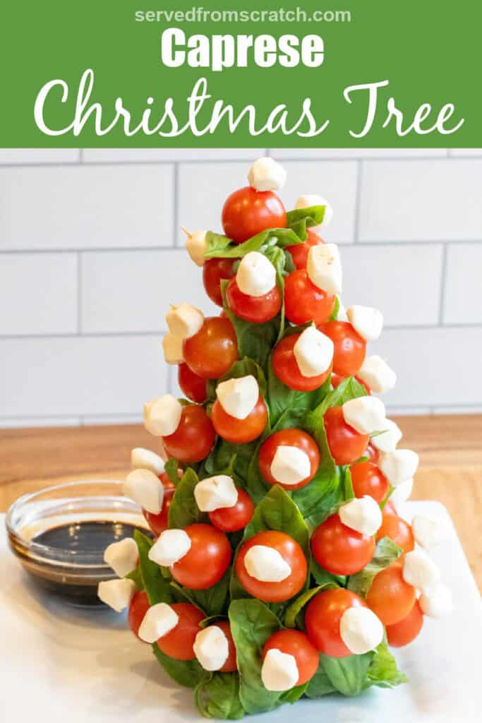 a christmas tree shaped caprese tree with a bowl of balsamic with Pinterest pin text.