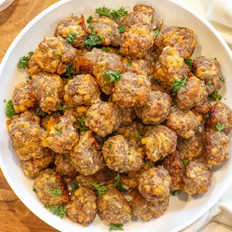 an overhead of a bowl of mini cheesy meatballs.