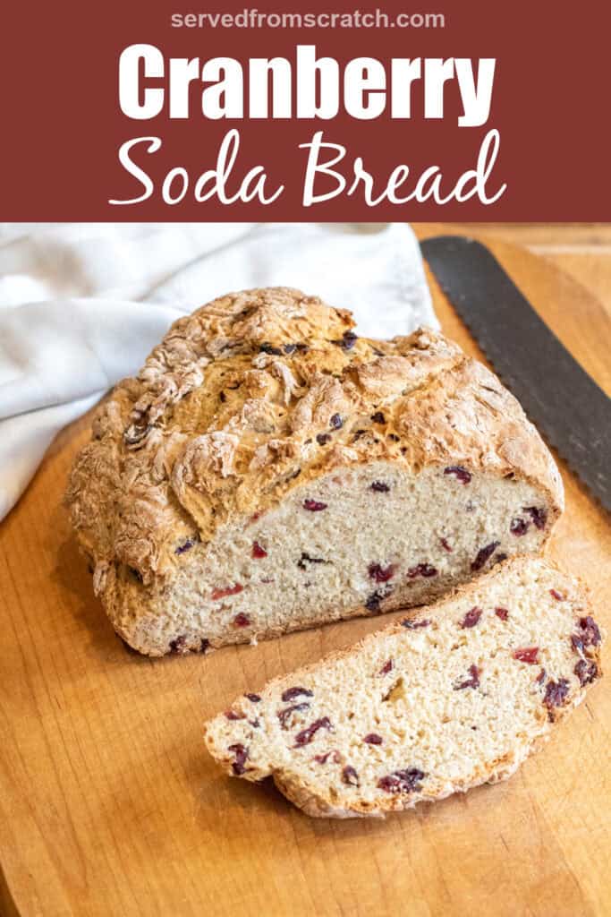 a loaf of bread with cranberries and a slice cut off with a bread knife with Pinterest pin text.