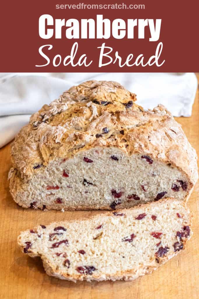 a loaf of bread with cranberries and a slice cut off with a bread knife with Pinterest pin text.