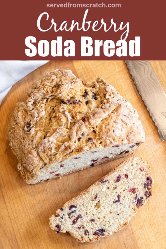 a loaf of bread with cranberries and a slice cut off with a bread knife with Pinterest pin text.