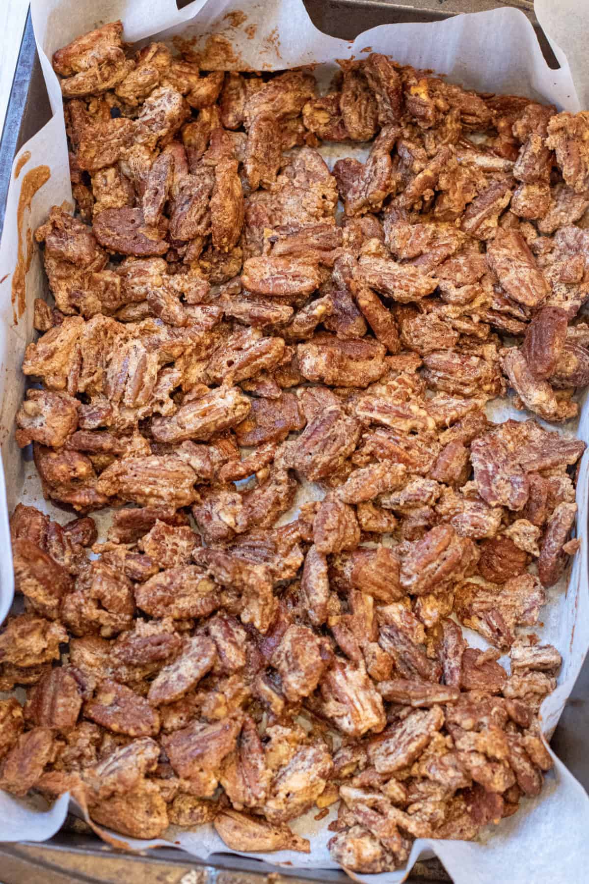 a tray of roasted crunchy coated pecans.