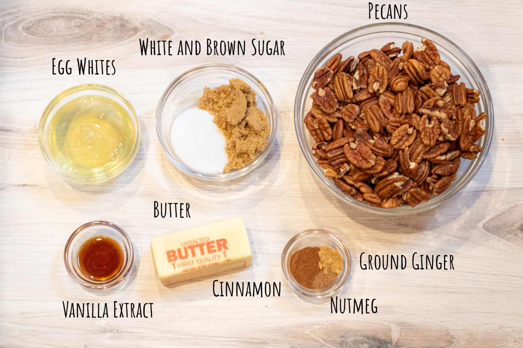 egg whites, sugars, pecans, vanilla extract, butter, and spices in bowls labeled.