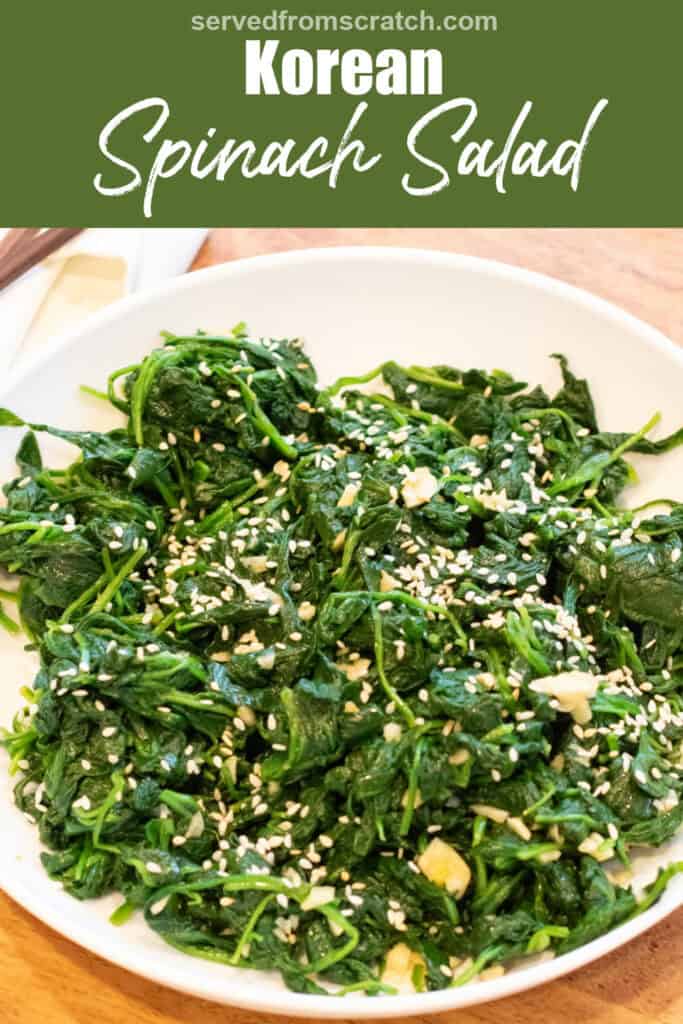 a bowl of blanched spinach with garlic and sesame seeds and chopsticks with Pinterest pin text.