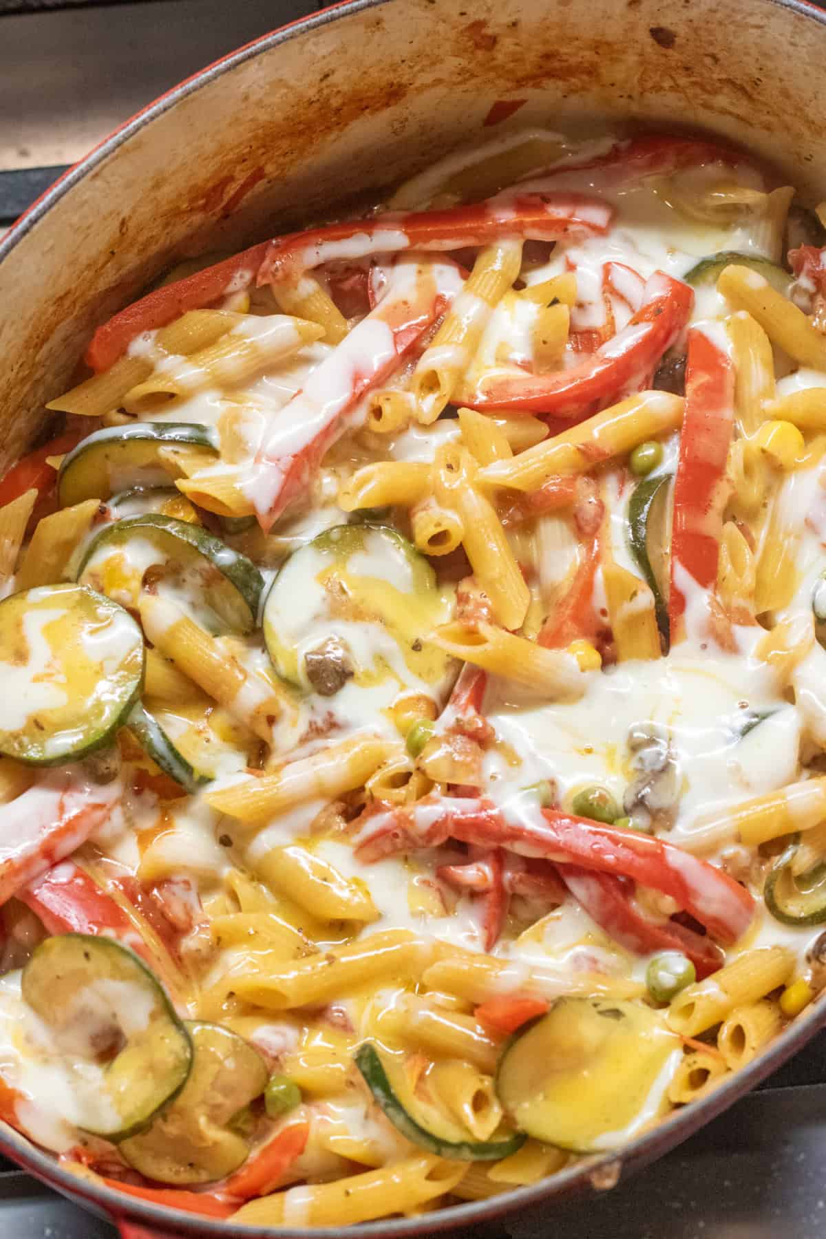 an overhead of cheesy pasta with veggies. 