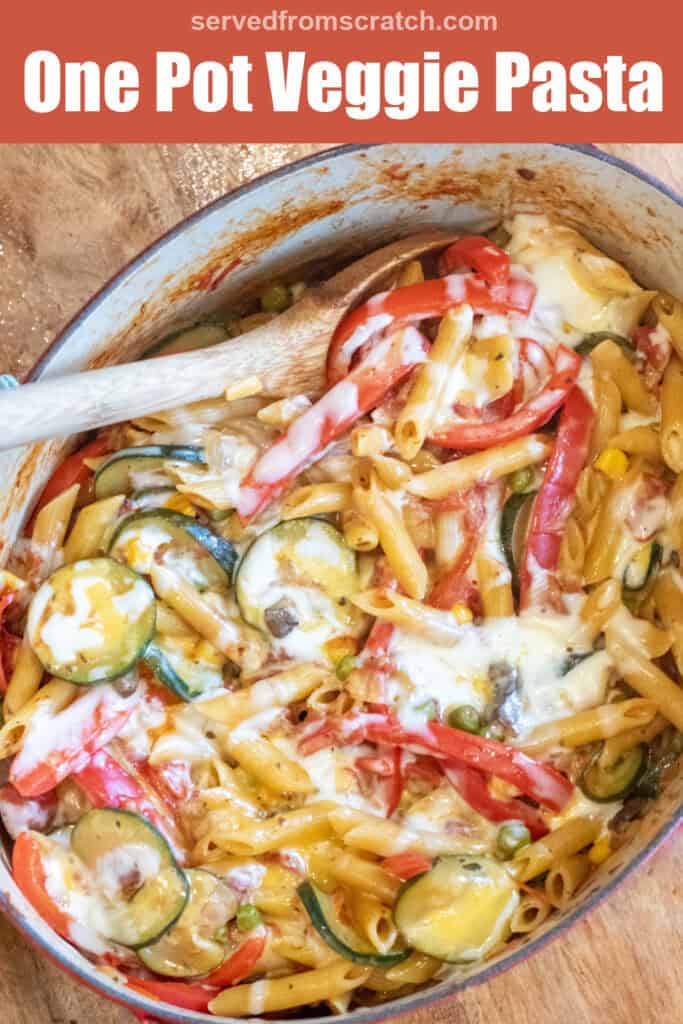 an overhead of cheesy pasta with veggies with a wooden spoon in it with Pinterest pin text.