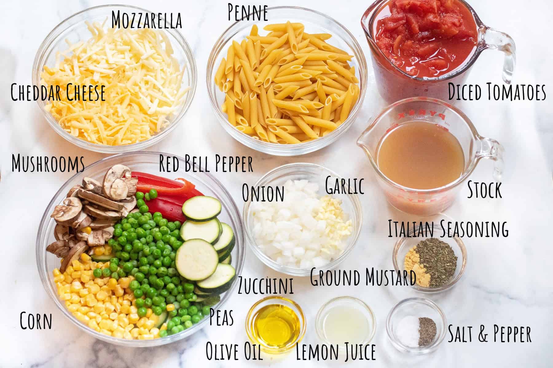 bowls of labeled cheeses, diced tomatoes, pasta, veggies, chicken stock, seasonings, oil, and lemon juice.