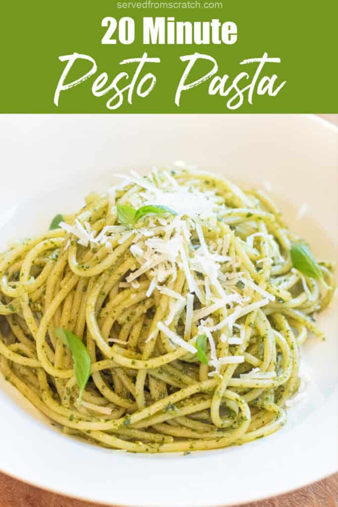 a bowl of pesto pasta with basil leaves and parmesan cheese on top with Pinterest pin text.