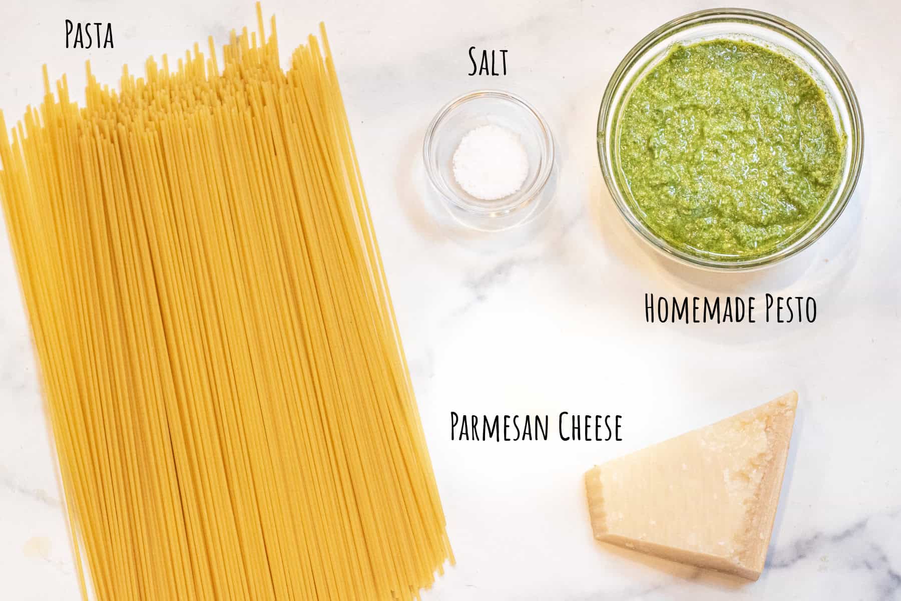spaghetti pasta, salt, Parmesan cheese, and a bowl of pesto labeled.