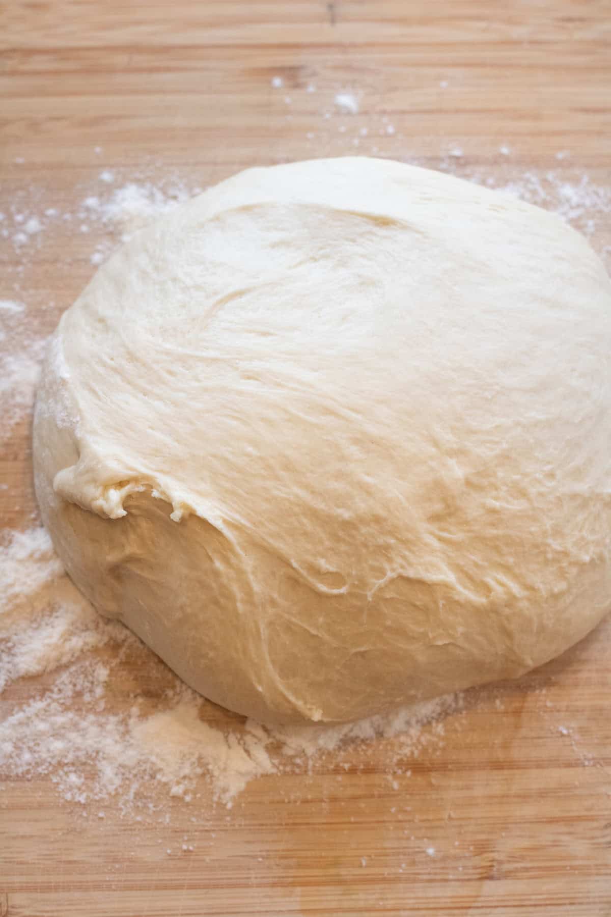 a dough ball on a floured cutting board. 