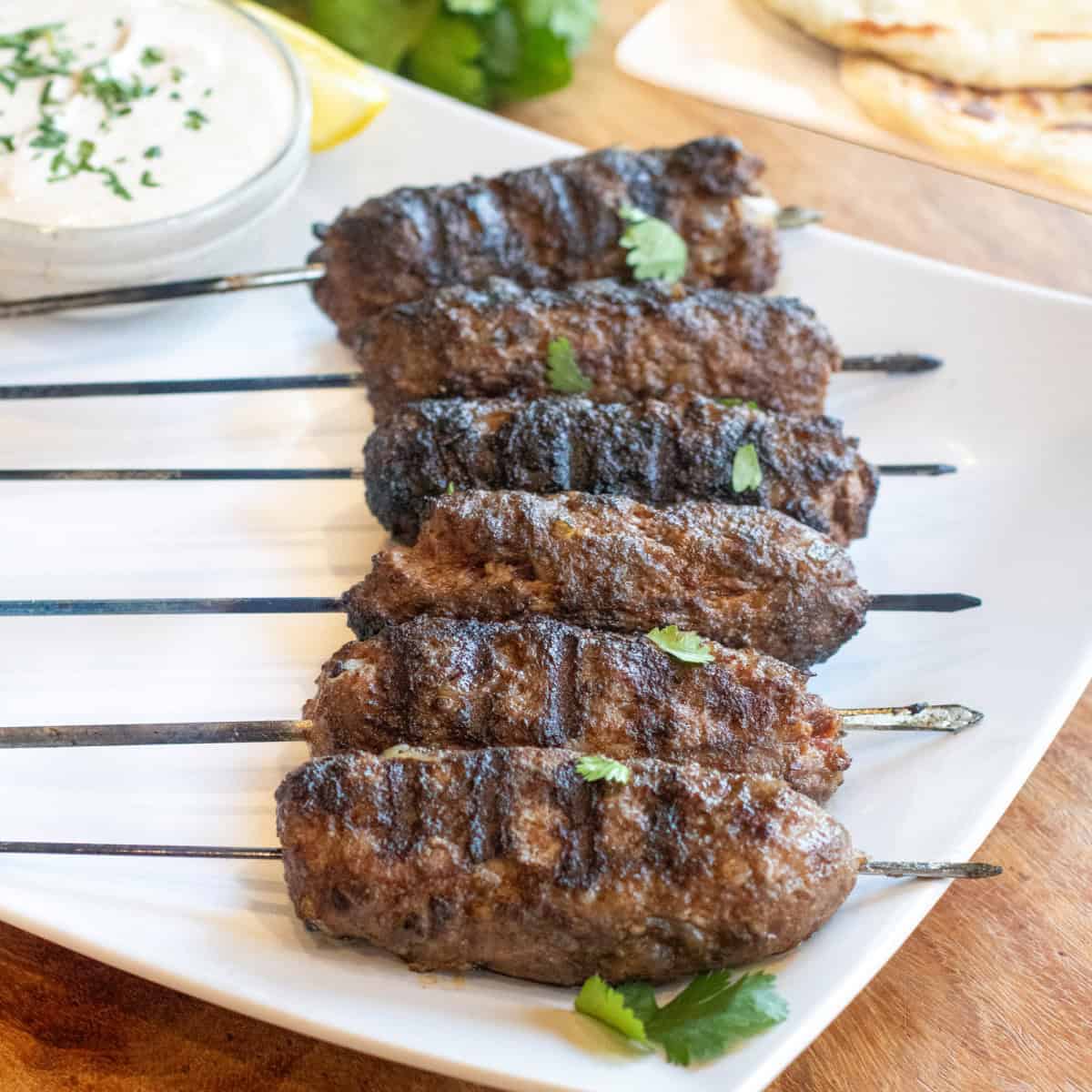 a plate of grilled lamb kebabs on a plate.