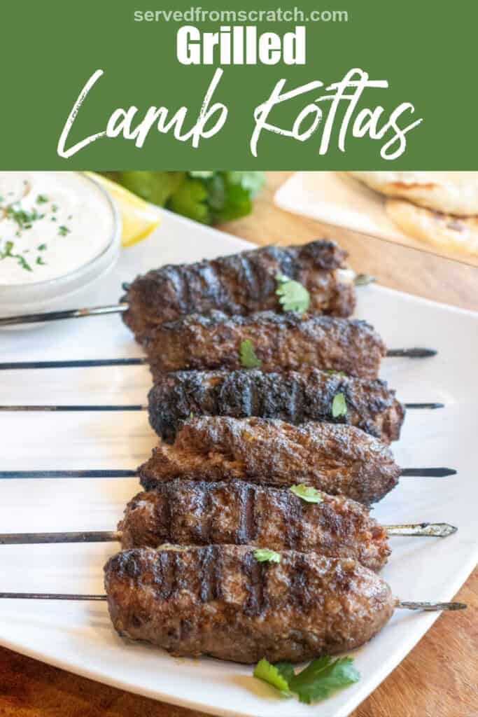 grilled cooked kofta skewers on a plate with a bowl of yogurt sauce and next to a plate of naan and some cilantro with Pinterest pin text.