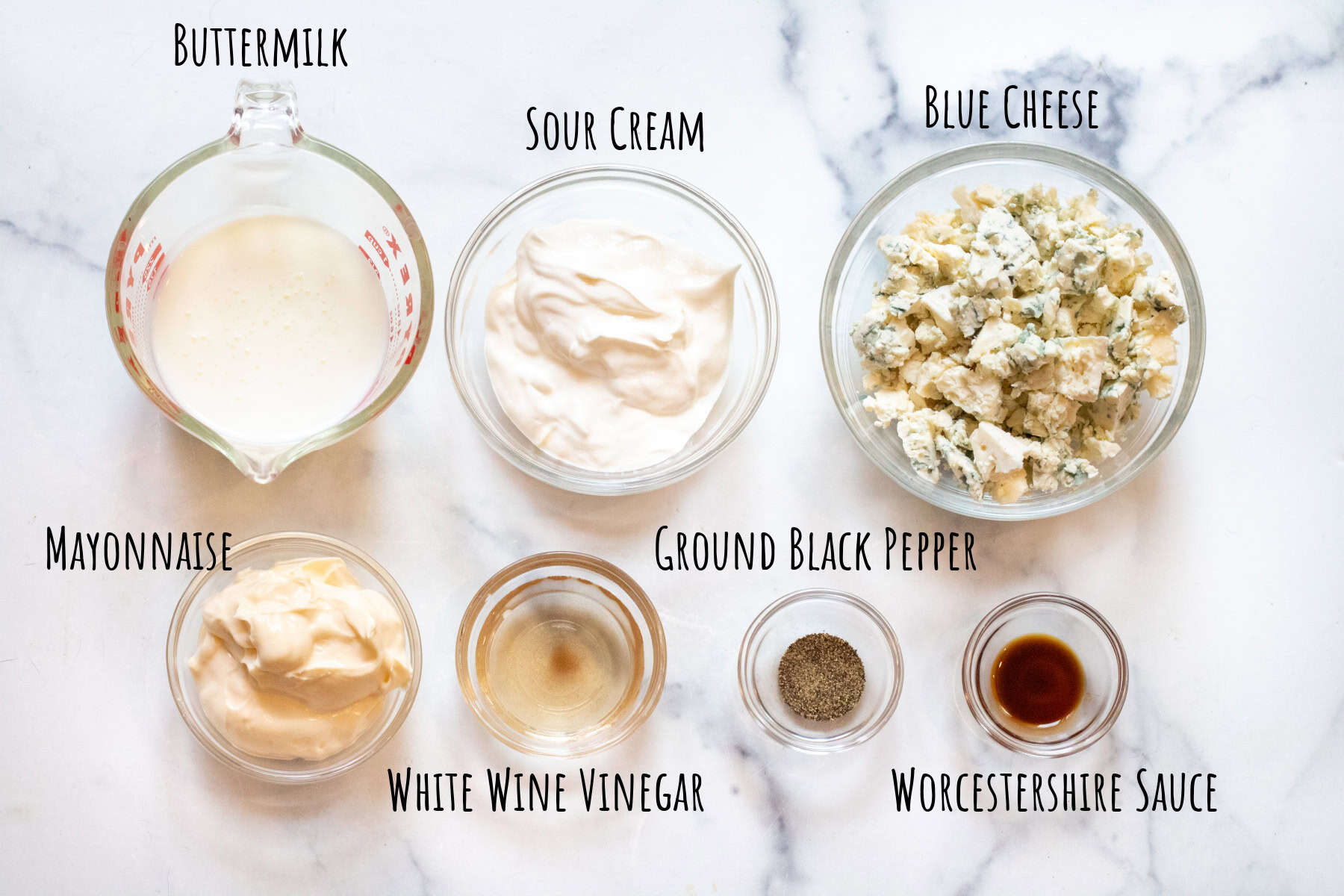bowls of buttermilk, sour cream, blue cheese, mayonnaise, vinegar, worscheshire sauce, and black pepper labeled. 