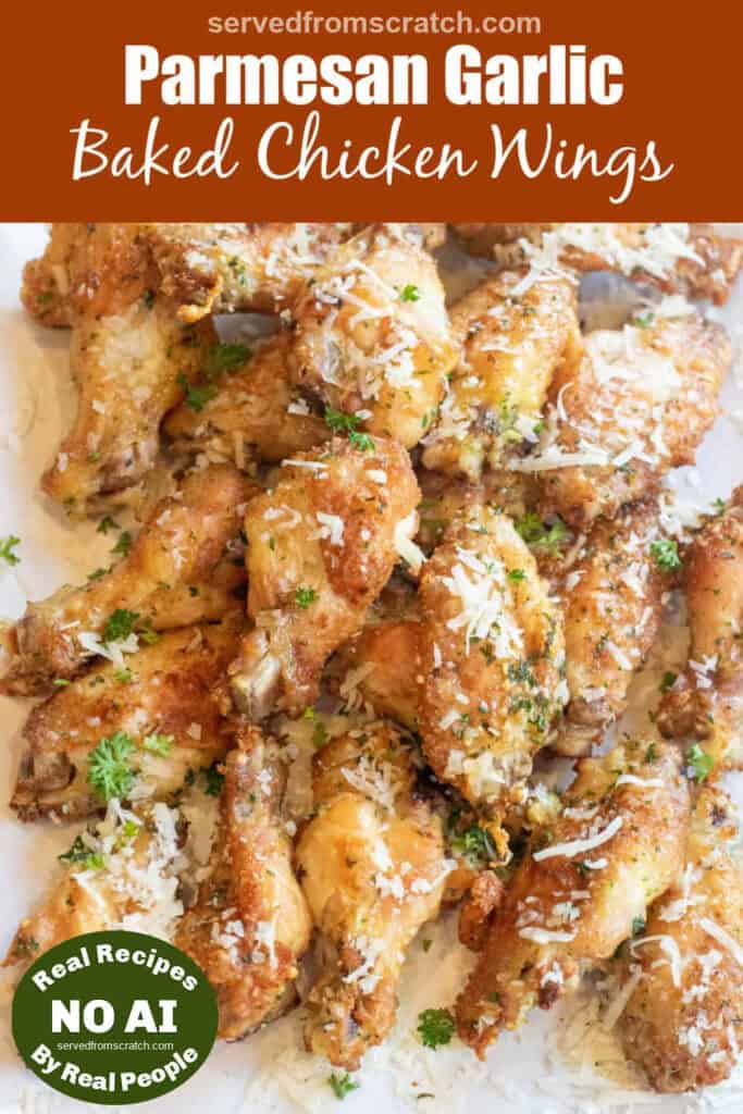 a plate of baked chicken wings with parsley and parmesan sprinkled on top with Pinterest pin text with NO AI sticker.
