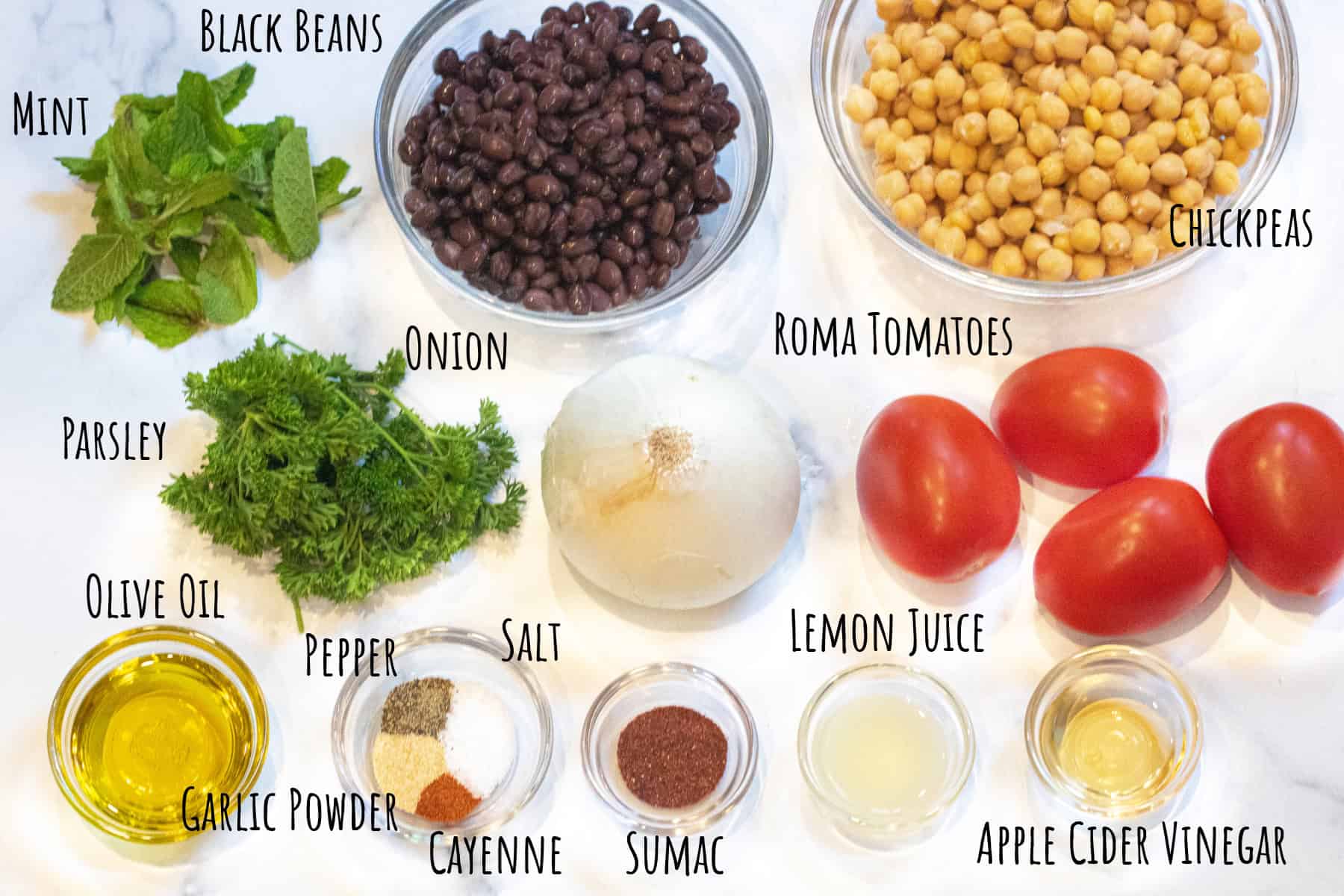 basil, mint, black beans, chickpeas, onion, tomatoes, oil, spices, lemon juice, vinegar, all labeled.
