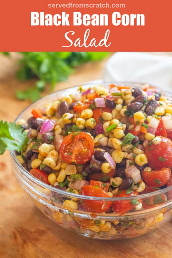 a large bowl of a corn and black bean salad with halved tomatoes and herbs with Pinterest pin text.