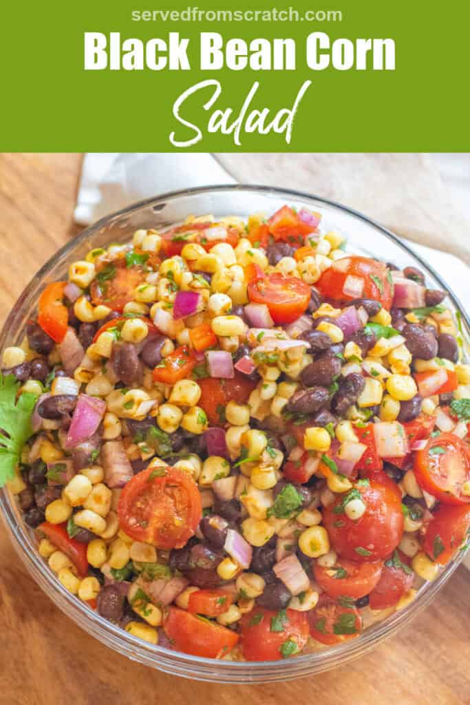 a large bowl of a corn and black bean salad with halved tomatoes and herbs with Pinterest pin text.