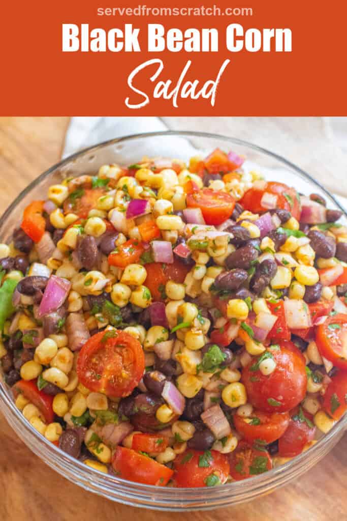 a large bowl of a corn and black bean salad with halved tomatoes and herbs with Pinterest pin text.