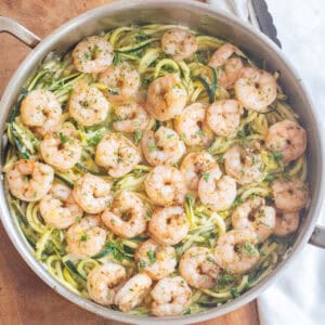 an overhead of a pan with cooked shrimp and zoodles.
