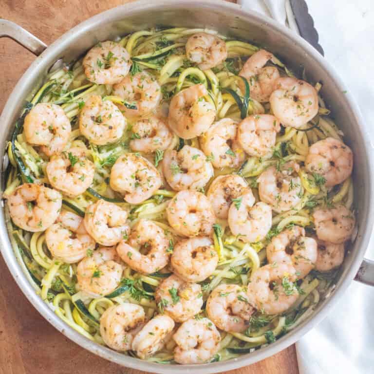 an overhead of a pan with cooked shrimp and zoodles.
