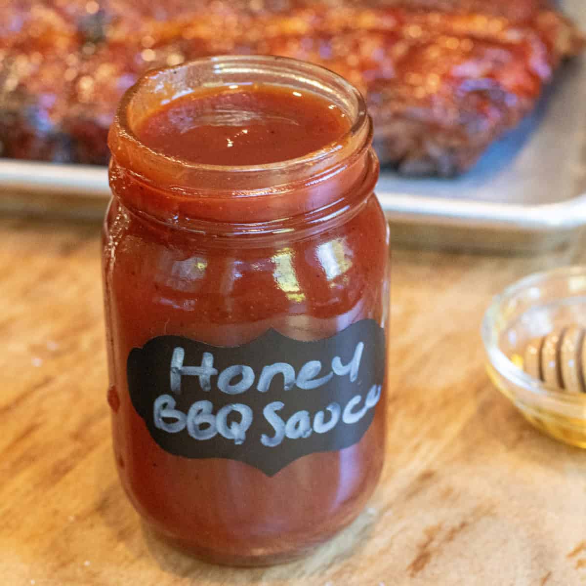 an open jar of honey bbq sauce.